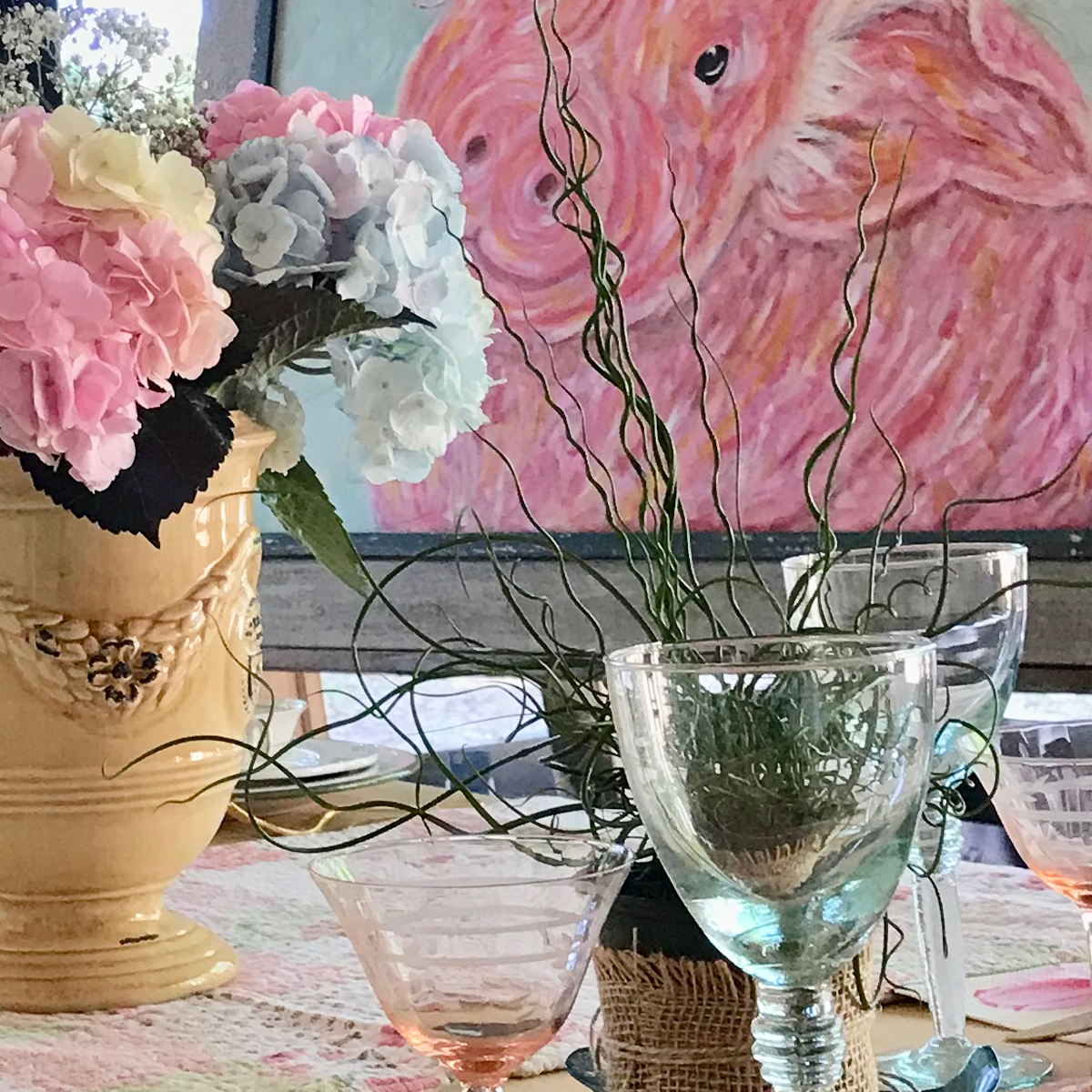 colorful flower centerpiece, pig painting, glassware
